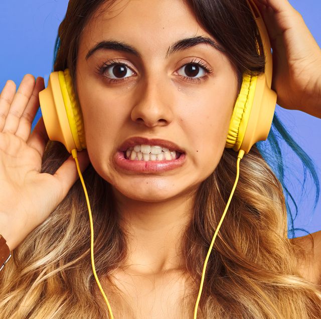 person with confused look listening to headphones