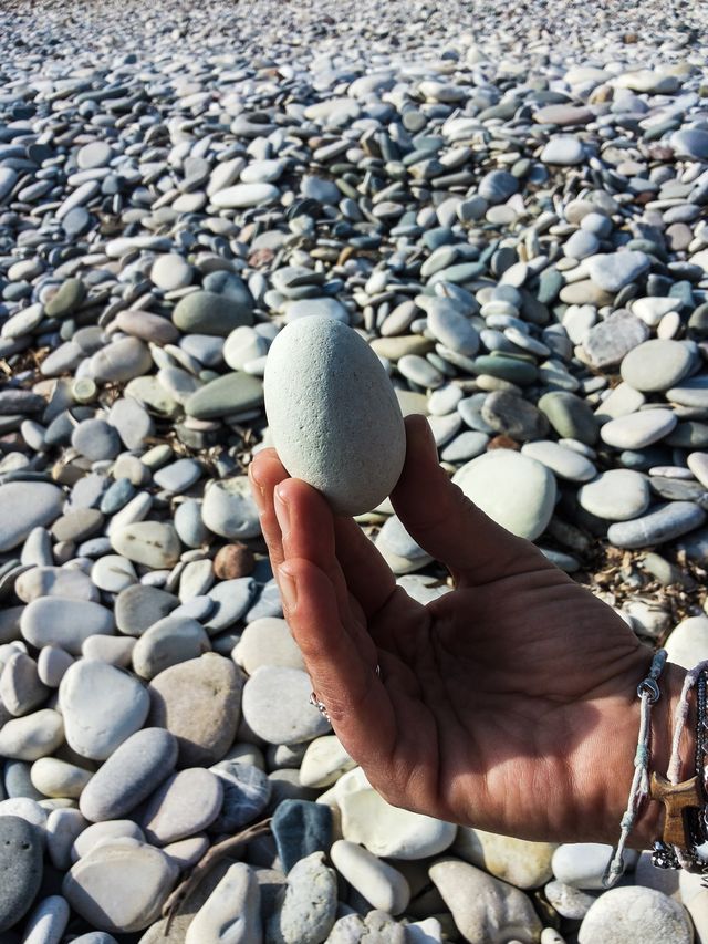 cropped hand of person holding stone