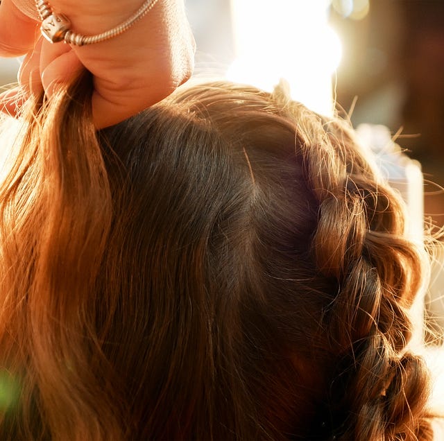 Cropped Hands Of Female Hairstylist Styling Girl Hair cropped hands of female hairstylist styling girl hair