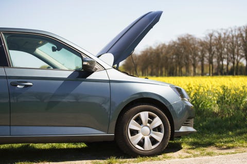 Cropped image of broken down car on roadside Cropped image of broken down car on roadside