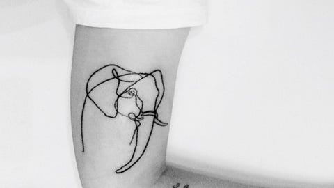 Cropped Image Of Hand With Tattoo On Bed cropped image of hand with tattoo on bed