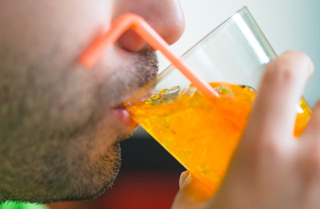 Cropped Image Of Man Drinking Juice From Glass cropped image of man drinking juice from glass