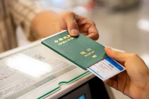 cropped image of passenger receiving boarding pass