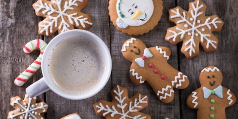 Cup of hot chocolate or cocoa with gingerbread cookie christmas composition on vintage wooden table background.