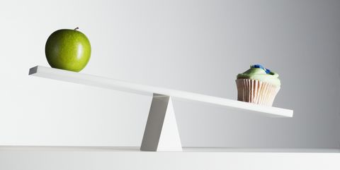 Cupcake tipping seesaw with green apple on opposite end