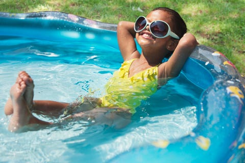 girl relaxing in kiddie pool