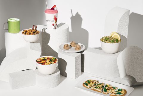 an assortment of prepared vegan meals on a white background from daily harvest, a good housekeeping pick for best healthy meal delivery service