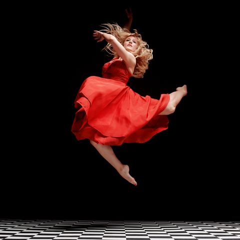 dancer in red dress in the air