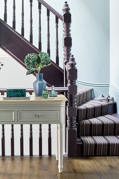 purple staircase with striped runner