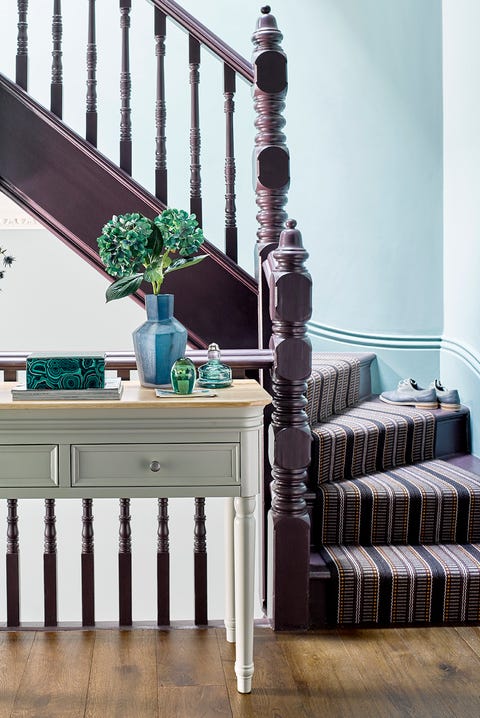 purple staircase with striped runner