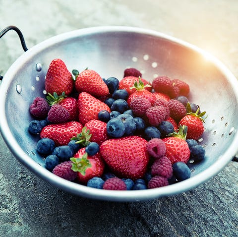 Strawberries, blueberries and raspberries in colander Strawberries, blueberries and raspberries in colander