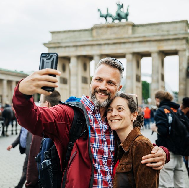 A Mature Couple Take A Selfie Together In Front Of Brandenburg Gate in Berlin