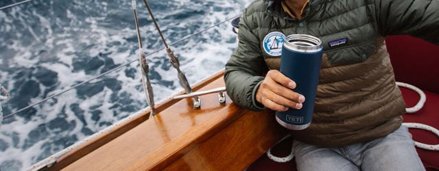 man sailing with yeti rambler