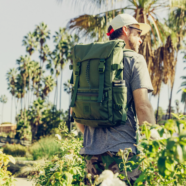 Topo Designs Rover Pack - Tech a model with an olive backpack in a jungle