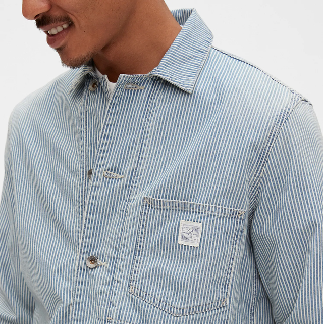 Gap Chore Jacket a model wearing a blue railroad stripe chore jacket