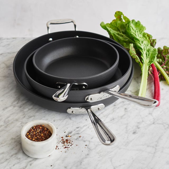 All-Clad Ha1 Non-Stock Set of 3 Skillets three skillets and some cooking ingredients