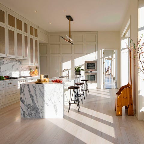 A List 2022 - ELLE DECOR spare living area with floor to ceiling windows in a gallery view