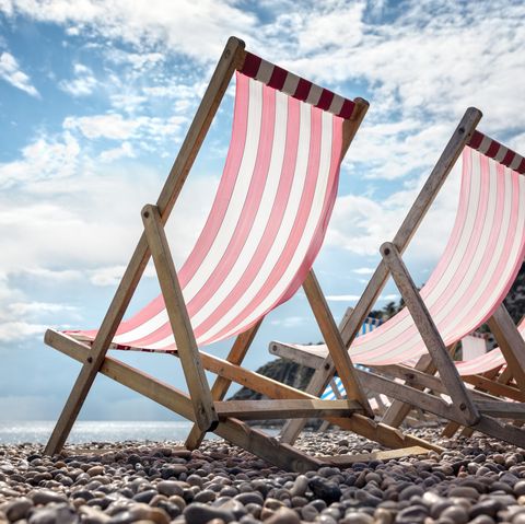 Deck chairs on the beach at the seaside summer vacation