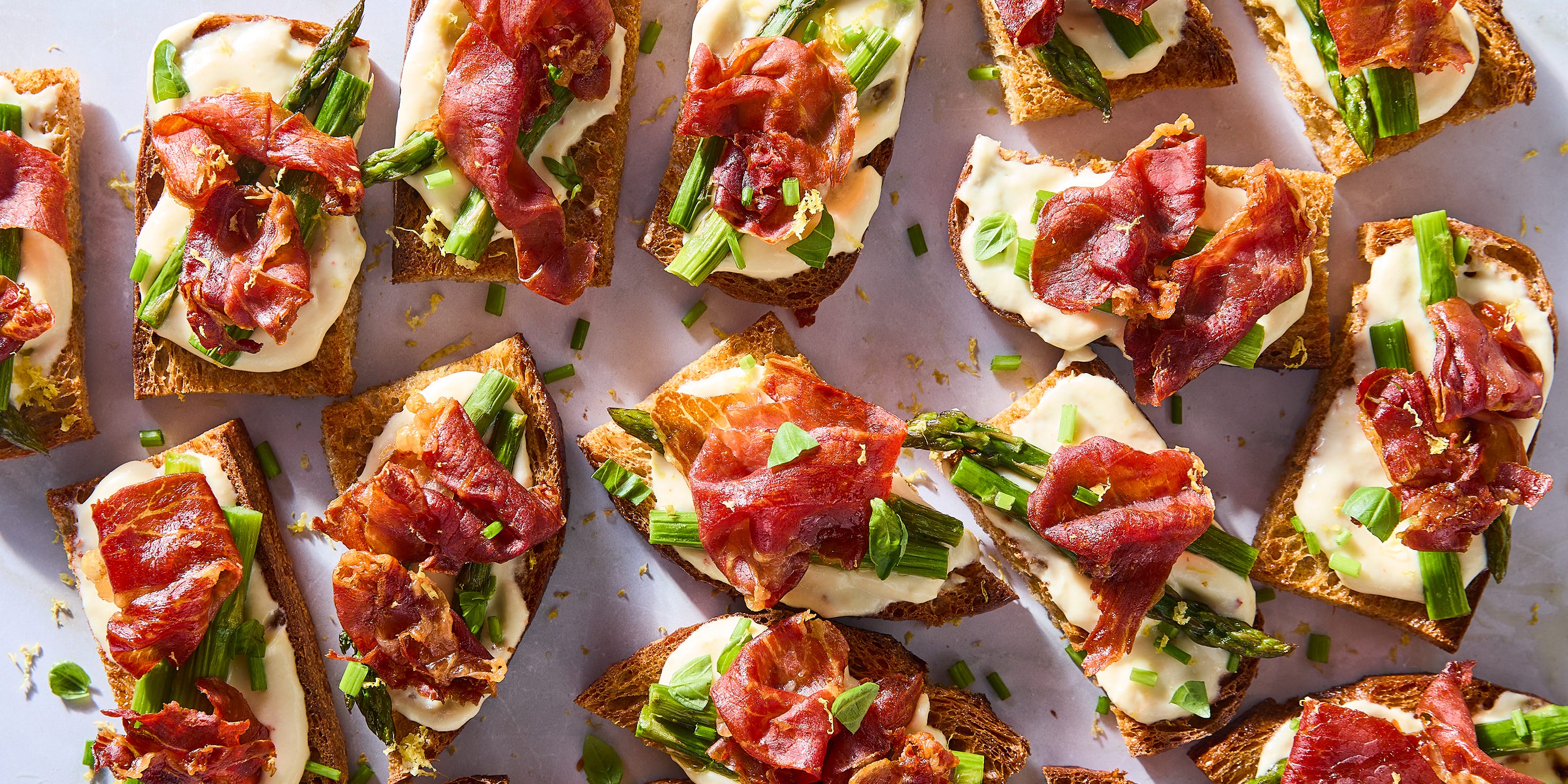 Crispy Prosciutto & Asparagus Mini Toasts Are The Best Last-Minute Spring Appetizer