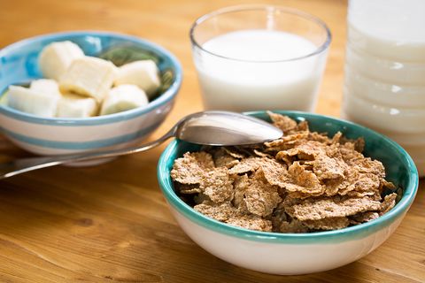 Delicious and healthy wheat flakes in bowl with milk