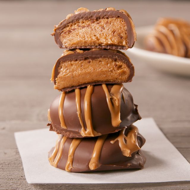 three chocolate covered peanut butter cookies stacked on top of each other
