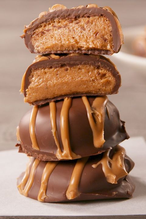 a close up of a few chocolate covered peanut butter cookies stacked on each other