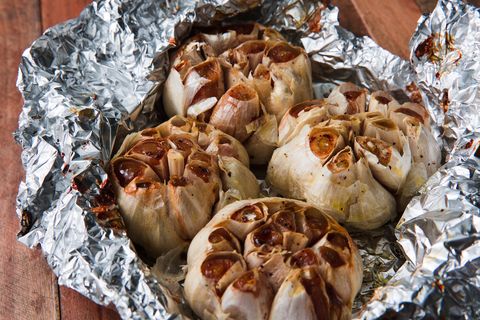 4 cloves of golden roasted garlic partially wrapped in aluminum foil