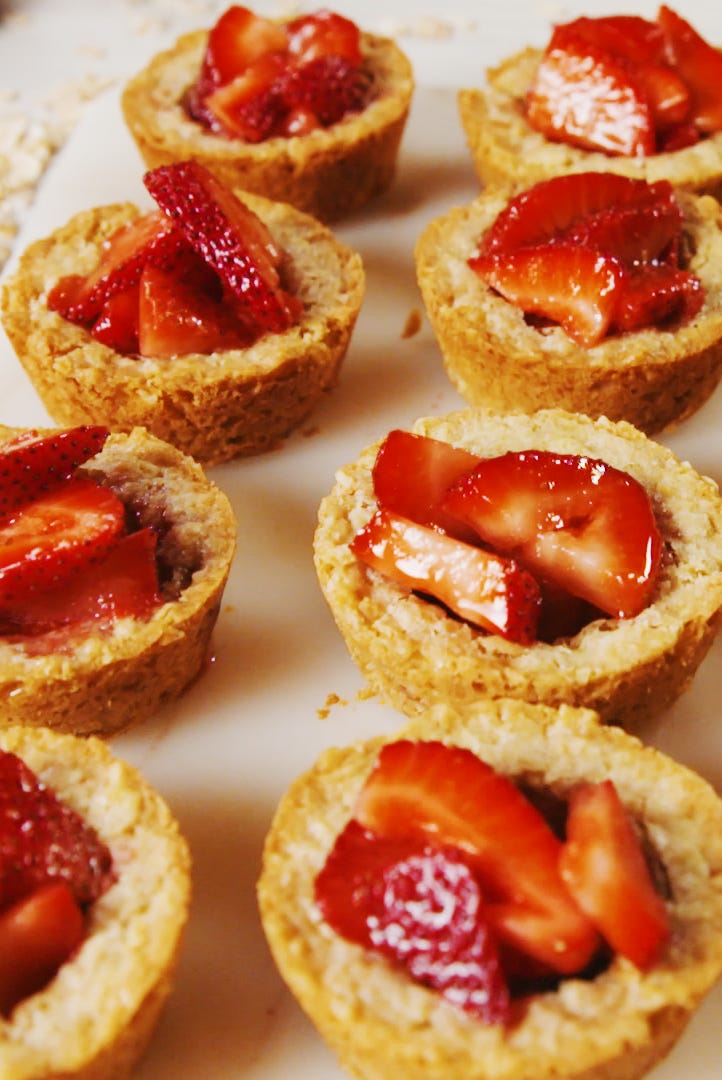 Strawberry crisp cookie cups with strawberry pieces and whipped cream
