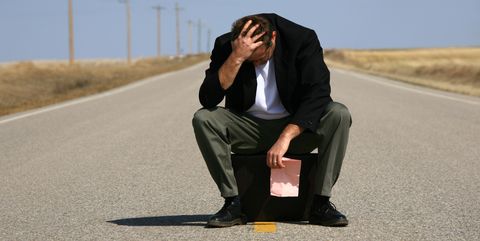 depressed businessman losing his job with pink slip