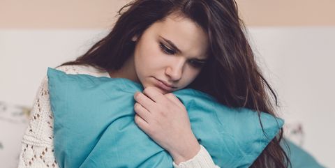 Depressed teenage girl in bed