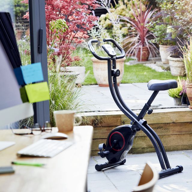 desk in home office and exercise bike
