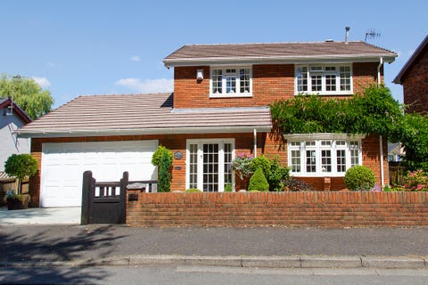 Detached four bedroom red brick house.