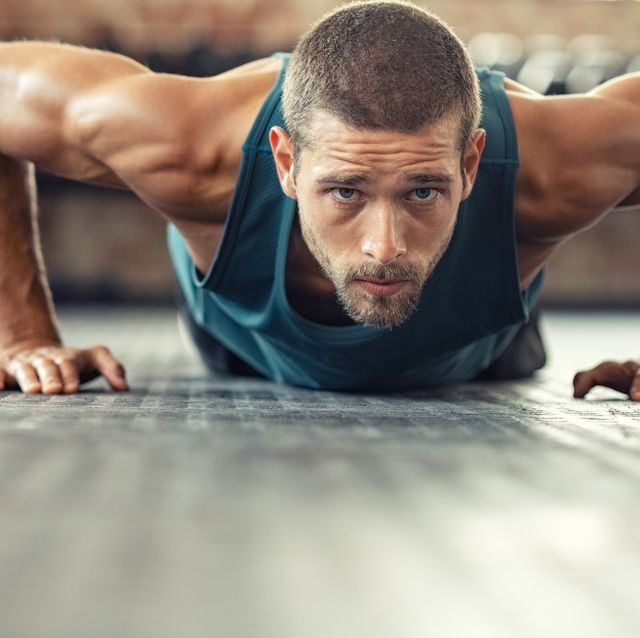 Determined man doing push ups at the gym