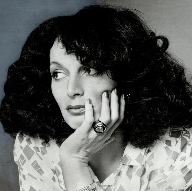 diane von furstenberg posing with hand on her face, looking off to the side