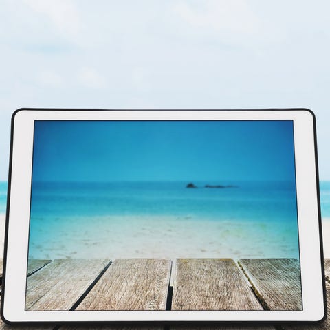 Digital Tablet with sunglasses on Wooden Desk at Tropical Beach digital tablet with sunglasses on wooden desk at tropical beach