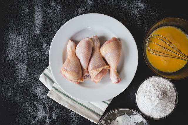 directly above of chicken in plate by ingredients on table