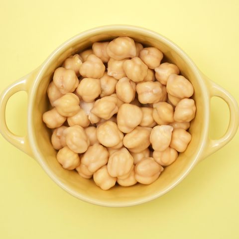 Directly Above Shot Of Chick-Peas In Bowl On Yellow Background