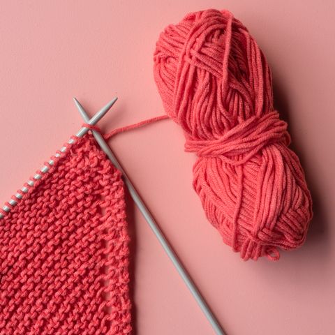 directly above shot of knitting needle with crochet on colored background