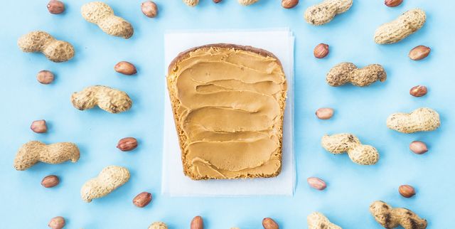directly above shot of peanut butter on bread against blue background