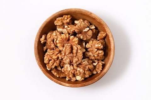 Directly Above Shot Of Walnuts In Bowl Against White Background