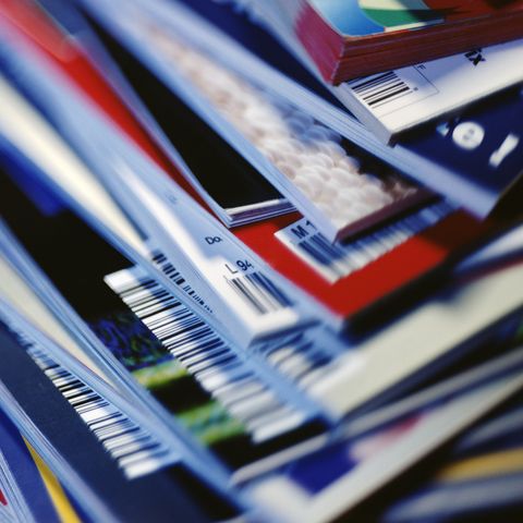 disorderly stack of magazines, extreme close up on corners with barcodes, full frame
