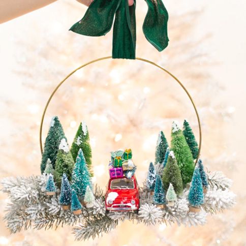 diy christmas wreaths, left image of a colorful balloon wreath, right image of a hoop adorned with vintage cars and fake christmas trees