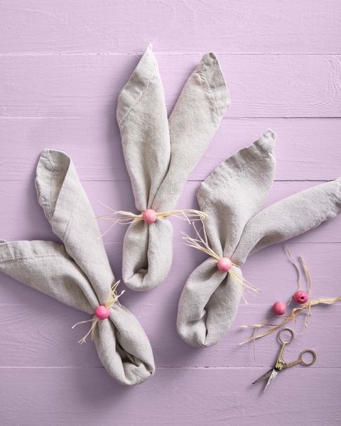 napkins folded into bunny ears with painted pink wooden craft ball noses