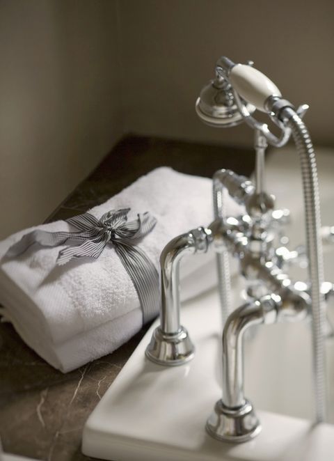 luxury bathroom detail with faucet, tub, and towels at luxury hotel