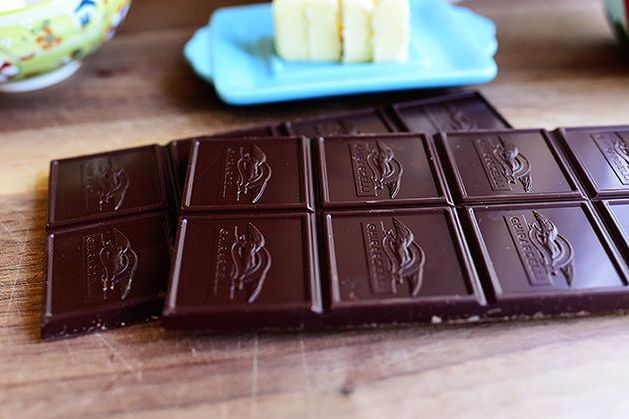 bars of ghirardelli chocolate on wood with butter in back