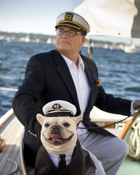 senior man sailing with dog