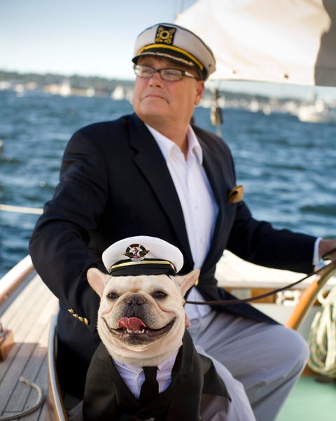 senior man sailing with dog