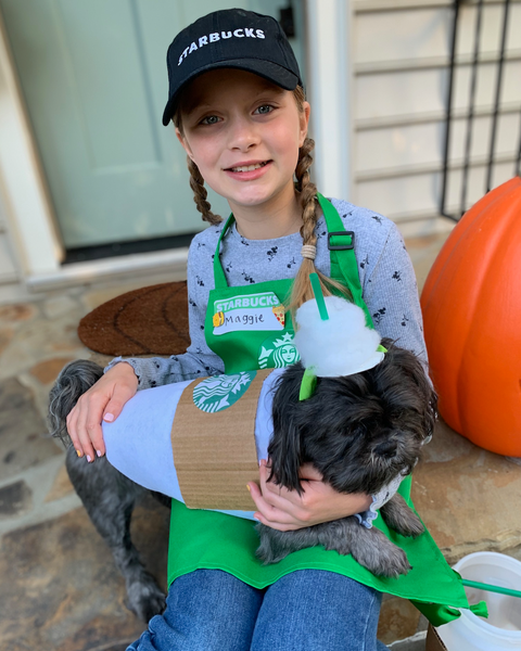 girl dressed as starbucks employee and dog dressed as puppuccino