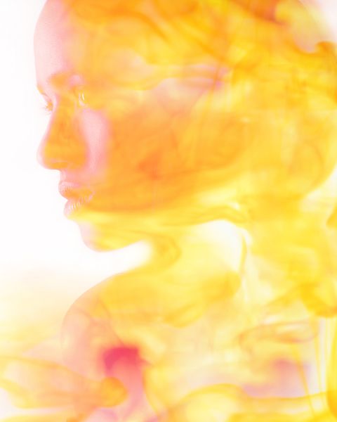 double exposure of face of mixed race woman and fire