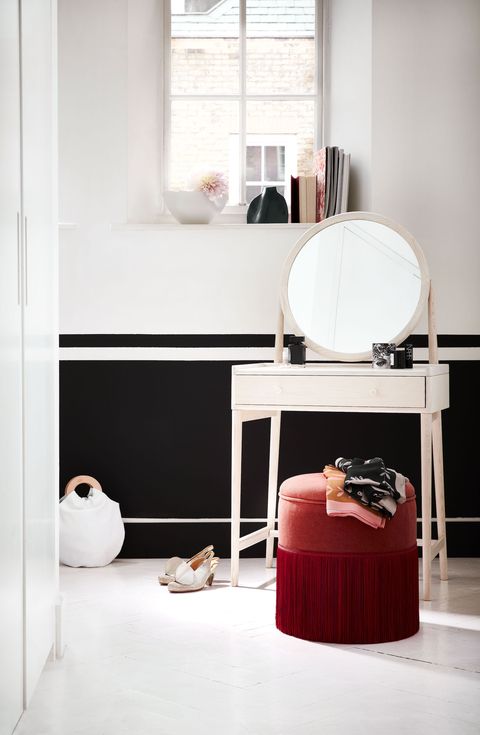 dressing room, white dressing table with round mirror, red stool poufe black and white wallswalk the linegive a feminine space edge with a bold monochrome striped walllower wall in pitch black estate emulsion, farrow ball salinadressing table, Â£630, ercol drum stool, Â £145, the dormy house upholstered in pebble paprika linen,Â£120m, christopher farr cloth barcelona ombrÃ© fringe in garnet, Â£110m, samuel sons